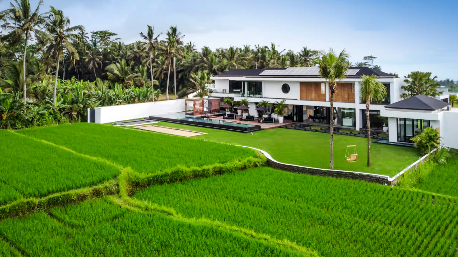 The house from above, standing on its own lawn with rice fields running up to the boundary on three sides